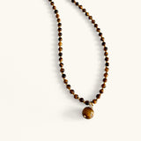 Close-up of tiger eye gemstone necklace with warm brown tones